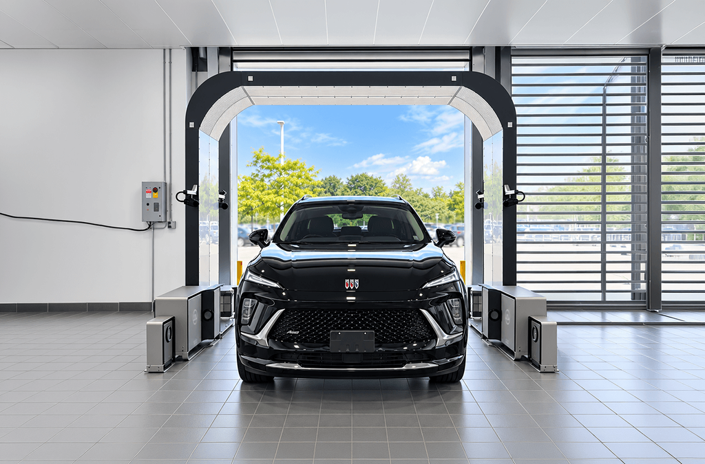 Car driving through a UVeye vehicle health scan system